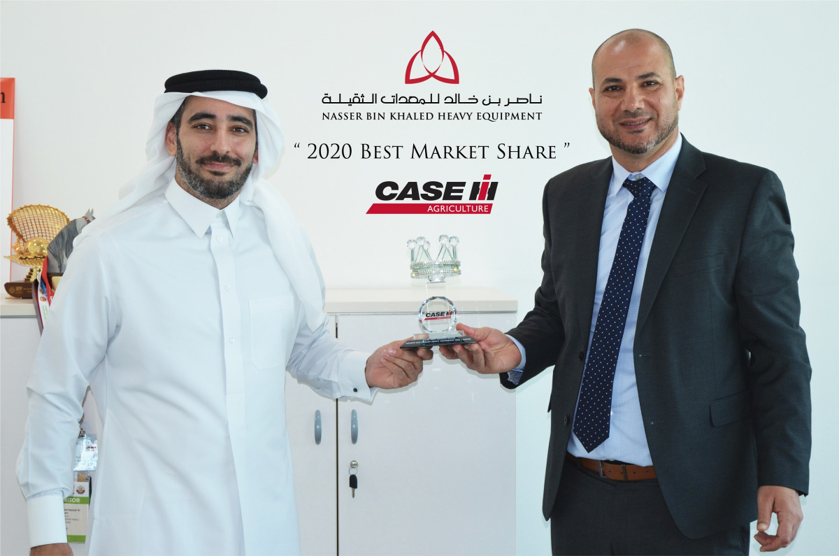 Eyad Rashid (right), General Manager at NBK Heavy Equipment, with an official in Doha.