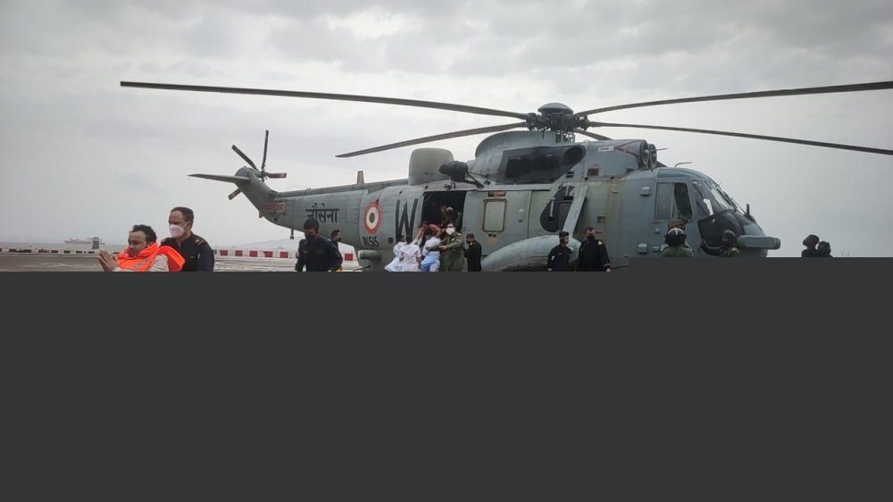 A man gestures after he was rescued by Indian Navy personnel from a sunken barge in the Arabian Sea in the aftermath of cyclone Tauktae's landfall, at naval air station INS Shikra in Mumbai, May 18, 2021. Indian Navy/Handout via Reuters