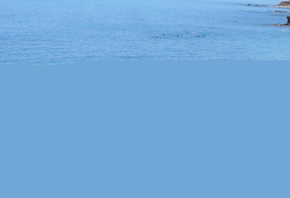 Migrants stand at the beach in Fnideq, close to the Spanish enclave Ceuta, in Morocco, May 19, 2021. REUTERS/Shereen Talaat