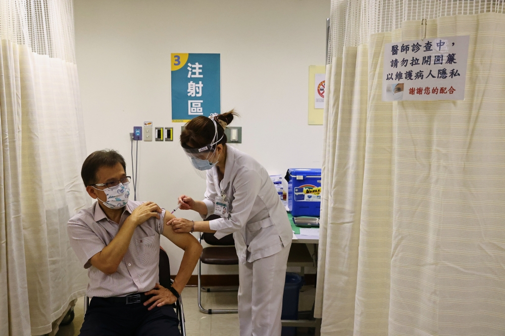 A nurse administers a dose of the AstraZeneca vaccine against the coronavirus disease (COVID-19) during a vaccination session for healthcare workers following the recent rise in COVID-19 infections, at Far Eastern Memorial Hospital in New Taipei City, Tai