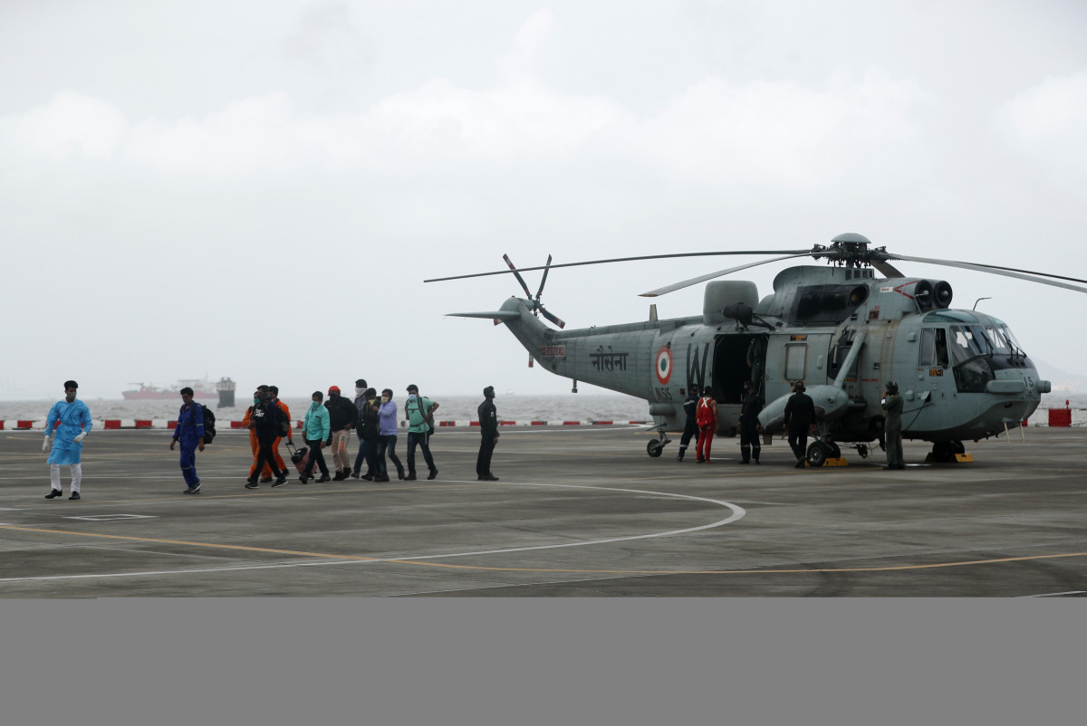 People who were stranded at sea due to Cyclone Tauktae exit an Indian Navy Sea King Mk.42C helicopter, after they were rescued by the Indian Navy, at INS Shikra, Colaba, Mumbai, India, May 18, 2021. REUTERS/Francis Mascarenhas
