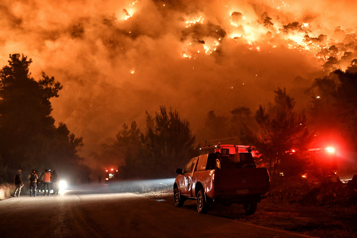 Flames rise as firefighters and volunteers try to extinguish a fire burning in the village of Schinos, near Corinth, Greece, May 19, 2021. Picture taken May 19, 2021. REUTERS/Vassilis Psomas TPX IMAGES OF THE DAY
