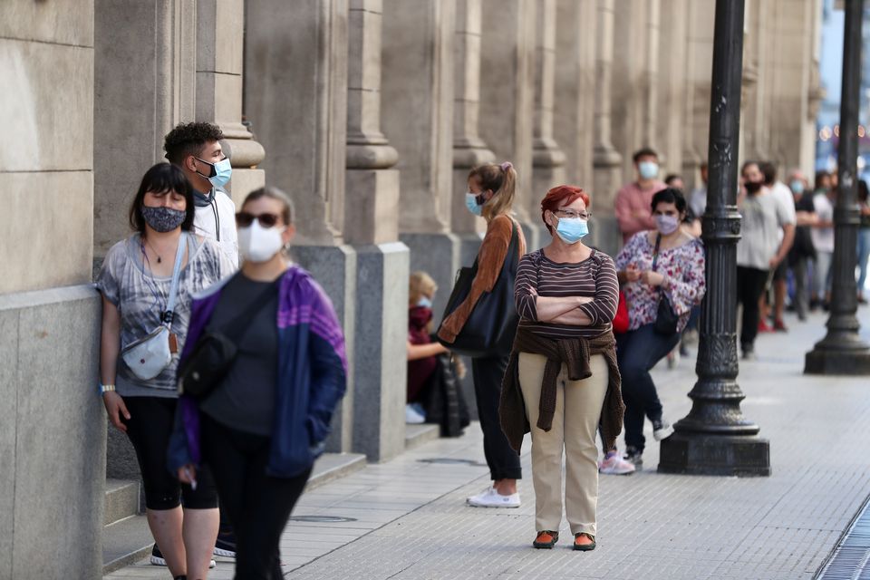 File photo: People wearing face masks wait in line to be tested for the coronavirus disease (COVID-19) at the Colon Theatre, in Buenos Aires, Argentina April 13, 2021. REUTERS/Agustin Marcarian