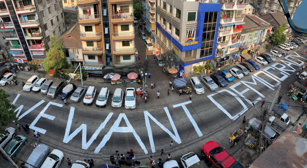 File photo: A slogan is written on a street as a protest after the coup in Yangon, Myanmar February 21, 2021. Reuters/Stringer/File Photo