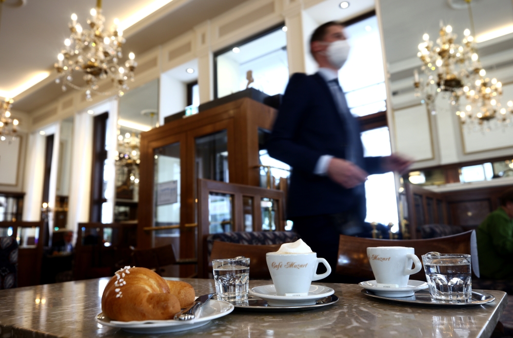 Coffee and a pastry are seen on a table inside Cafe Mozart, as the country eases its coronavirus disease (COVID-19) restrictions, in Vienna, Austria, May 19, 2021. Reuters/Lisi Niesner