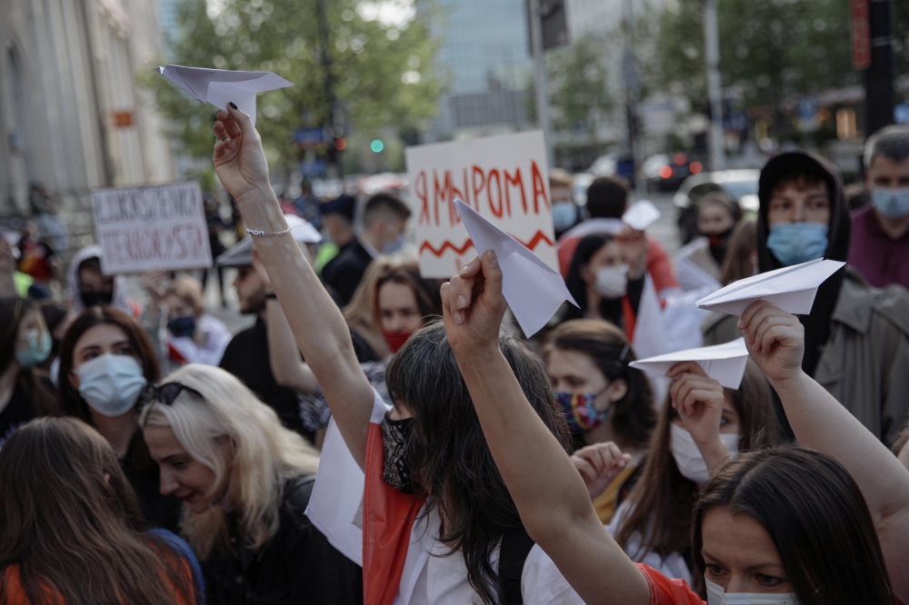 People hold paper planes during a protest against the detention of Belarusian blogger, Roman Protasevich, in Warsaw, Poland, May 24, 2021. Dawid Zuchowicz/Agencja Gazeta/via Reuters