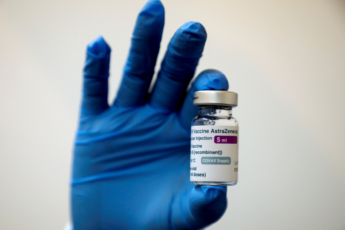 FILE PHOTO: A medical worker holds a bottle of AstraZeneca's COVID-19 vaccine at a vaccination centre  REUTERS/Lim Huey Teng/File Photo
