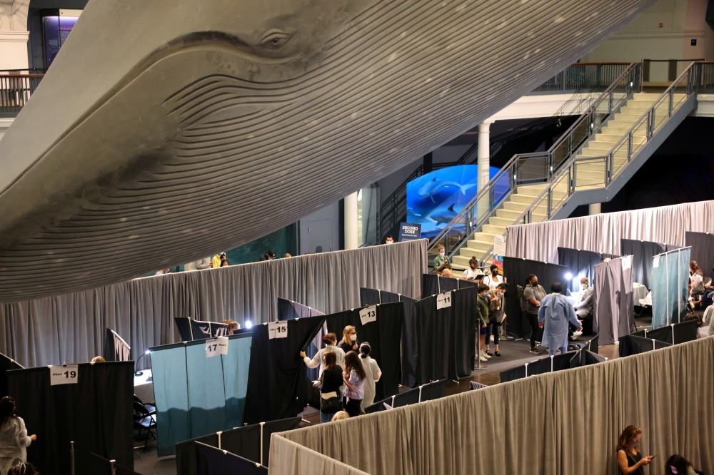 FILE PHOTO: People receive COVID-19 vaccines at the American Museum of Natural History in Manhattan, New York City, New York, U.S., May 14, 2021. REUTERS/Caitlin Ochs/File Photo
