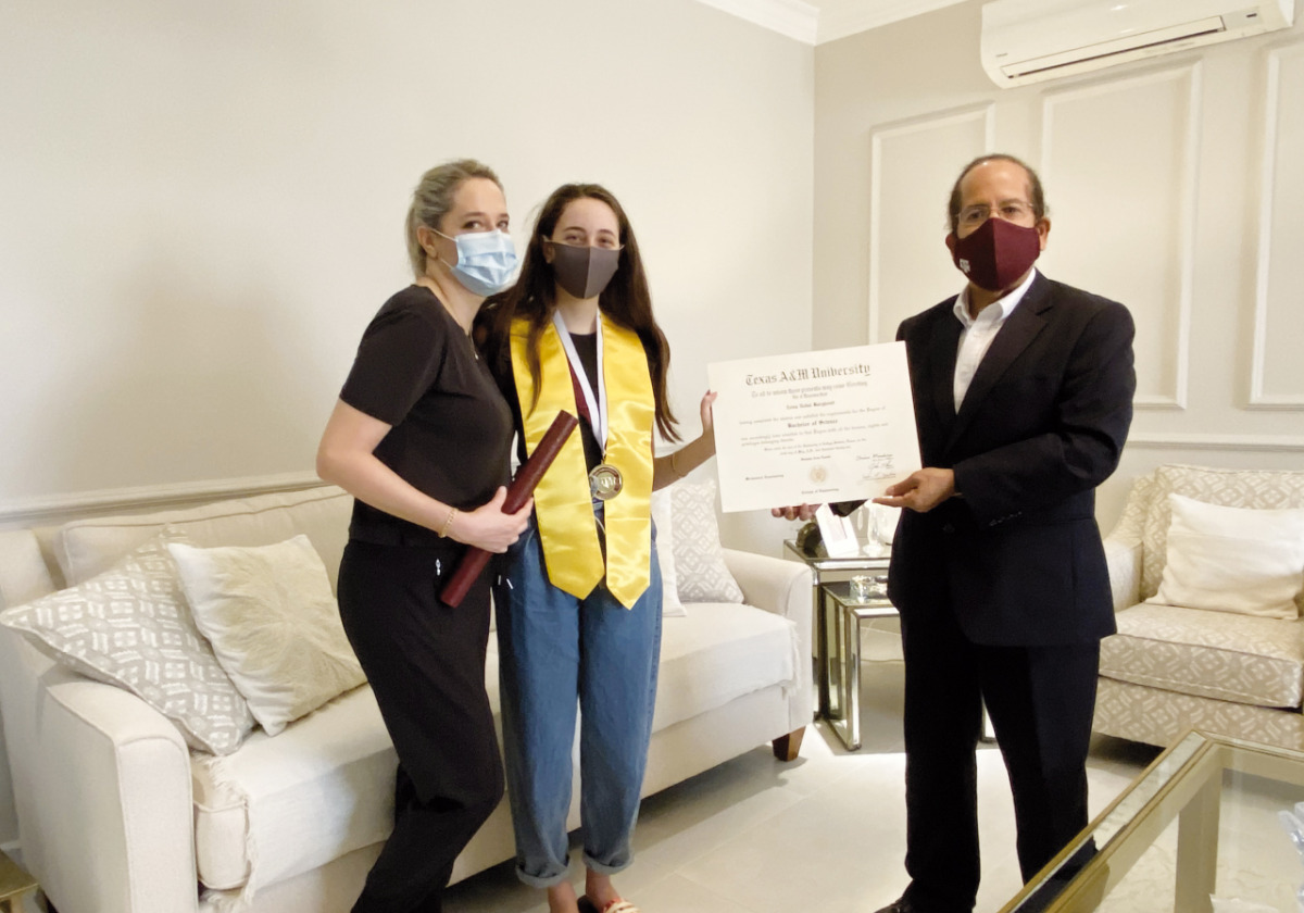 Dr. César Octavio Malavé, Dean of Texas A&M University at Qatar, presenting Zeina Barghouti her Mechanical Engineering degree certificate at home.