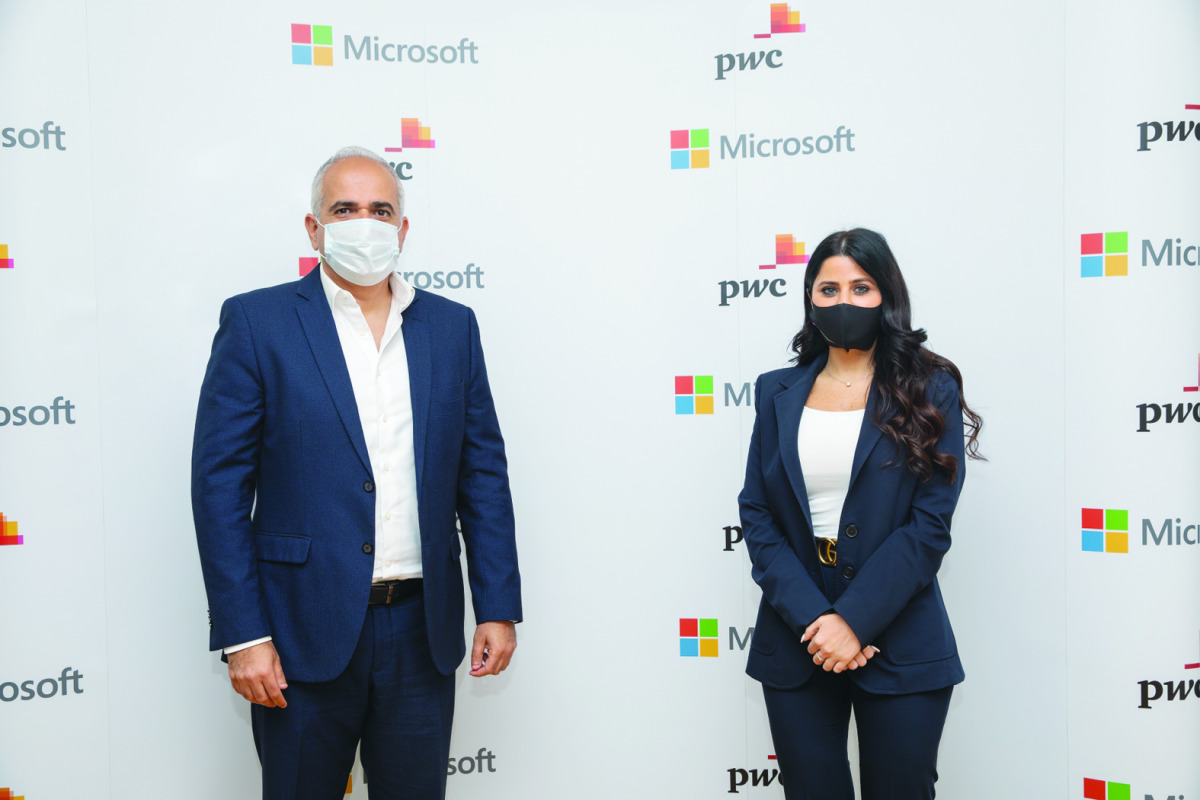 Officials of Microsoft and PwC pose for a photo.