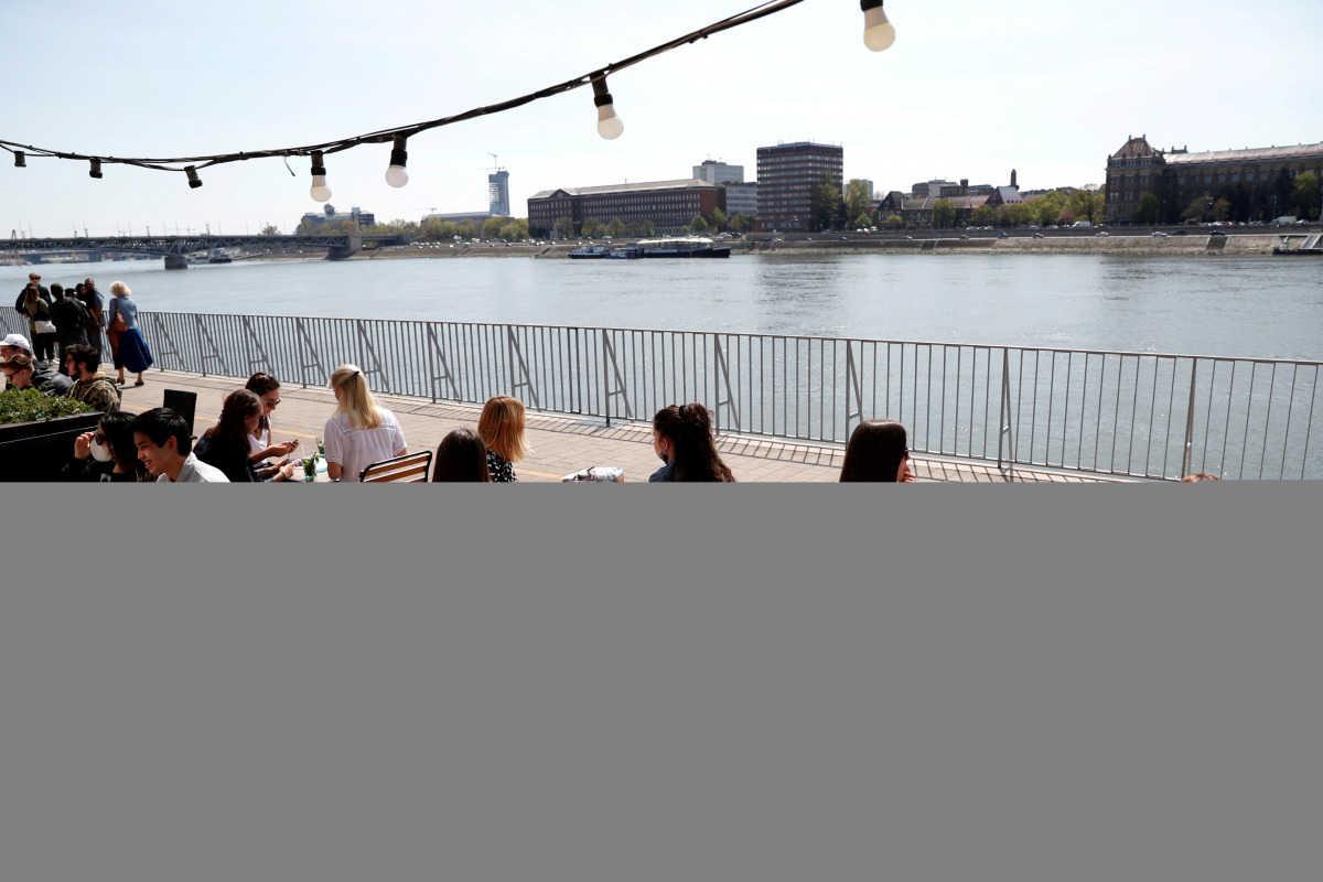 FILE PHOTO: Guests enjoy the sunny weather as they sit in front of a restaurant after the Hungarian government allowed to reopen outdoor terraces, as the spread of the coronavirus disease (COVID-19) continues in Budapest, Hungary, April 24, 2021. REUTERS/