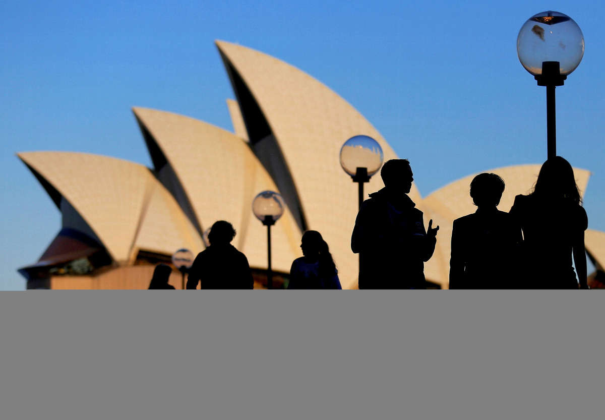 FILE PHOTO: People are silhouetted against the SYDNEY Opera House at sunset in Australia, November 2, 2016. REUTERS/Steven Saphore/File Photo
