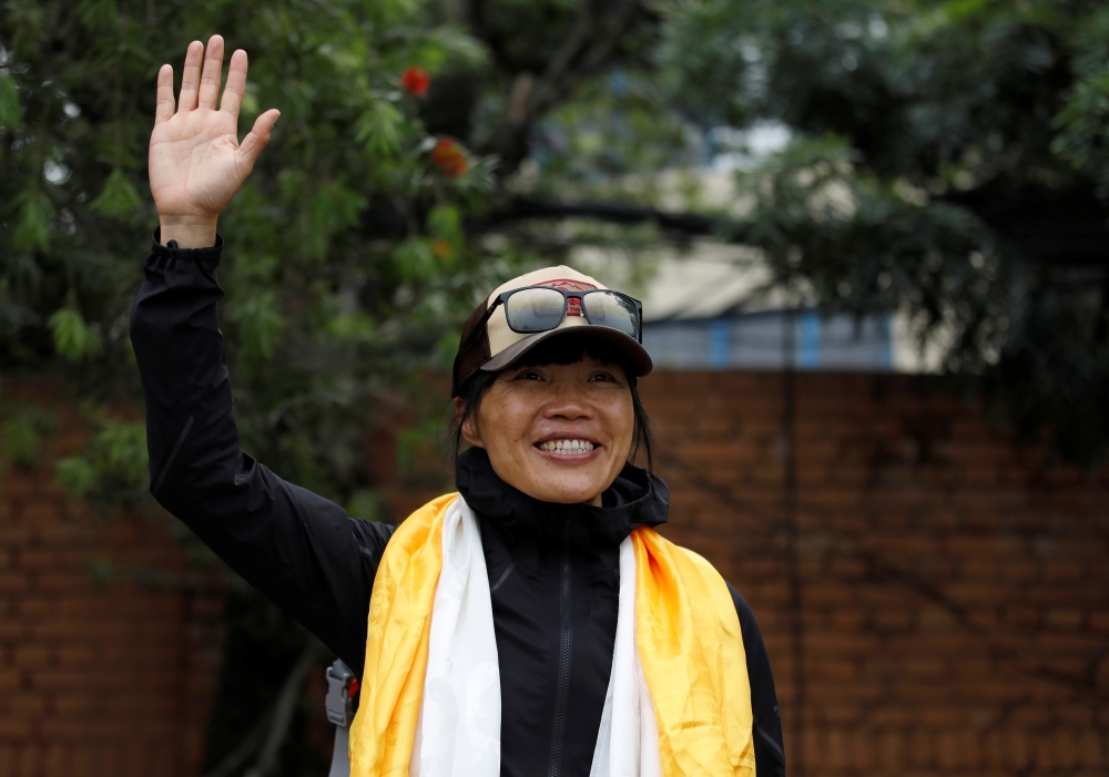Hong Kong's Tsang Yin-Hung, 45, who scaled Mount Everest in less than 26 hours, the shortest time taken by any woman after starting from the base camp, waves for a picture upon her arrival after climbing Everest, in Kathmandu, Nepal May 30, 2021. Reuters/