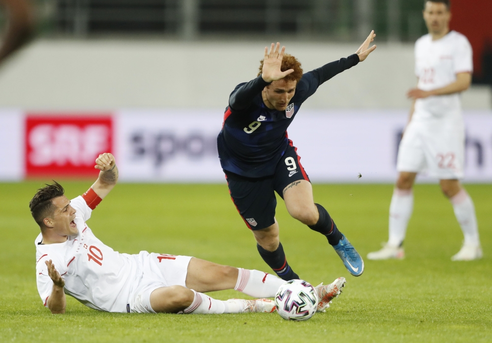 Switzerland's Granit Xhaka in action with Joshua Sargent of the US. (REUTERS/Arnd Wiegmann)