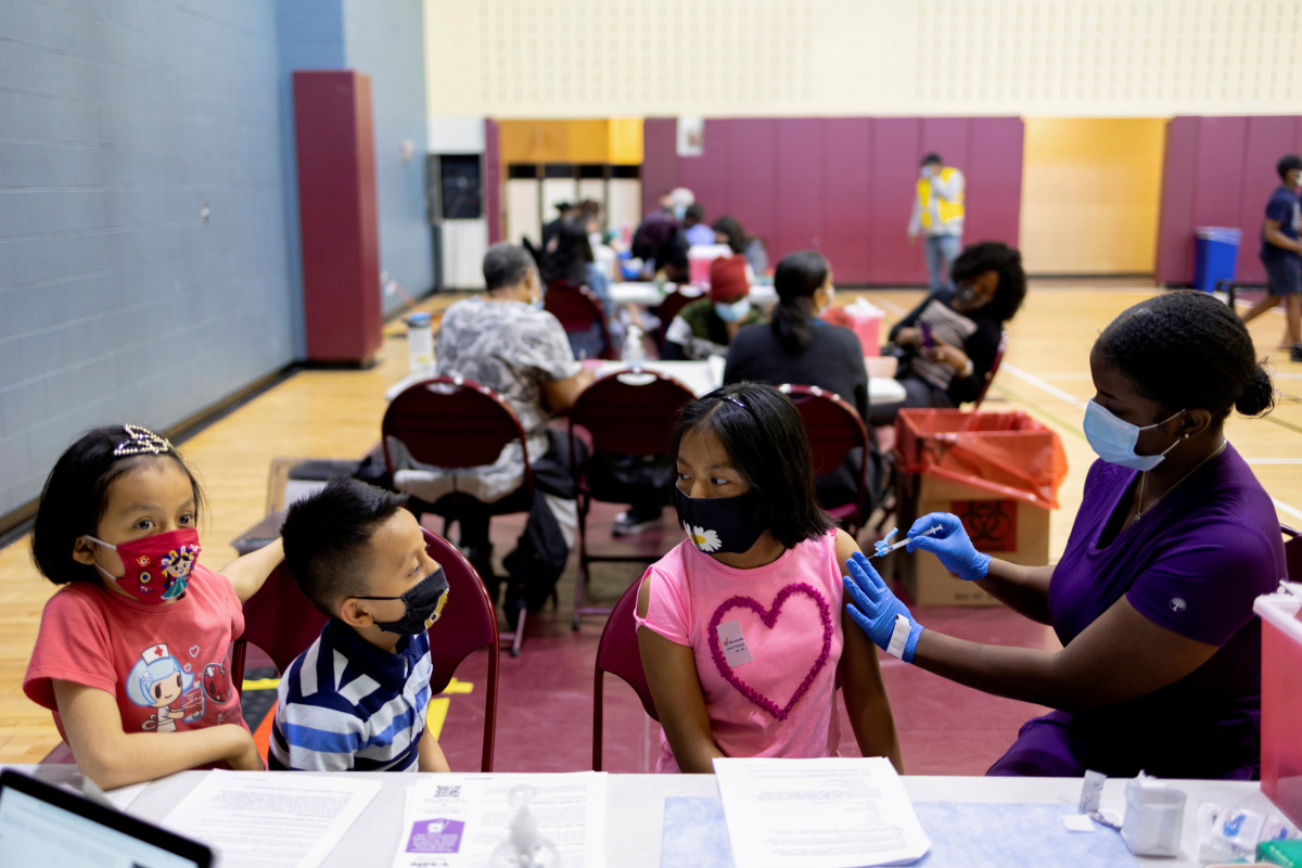 FILE PHOTO: Victoria Zaca, 12, receives a coronavirus disease (COVID-19) vaccine at a clinic run by the Philadelphia Department of Public Health in partnership with the Black Doctors COVID-19 Consortium to encourage all eligible teenagers to get vaccinate