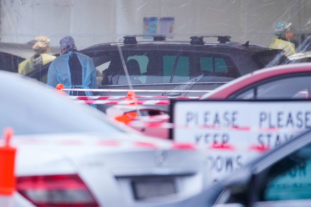 Healthcare workers administer coronavirus disease (COVID-19) tests at a drive-through testing centre on the first day of a seven-day lockdown, as the state of Victoria looks to curb the spread of an outbreak in Melbourne, Australia, May 28, 2021. REUTERS/