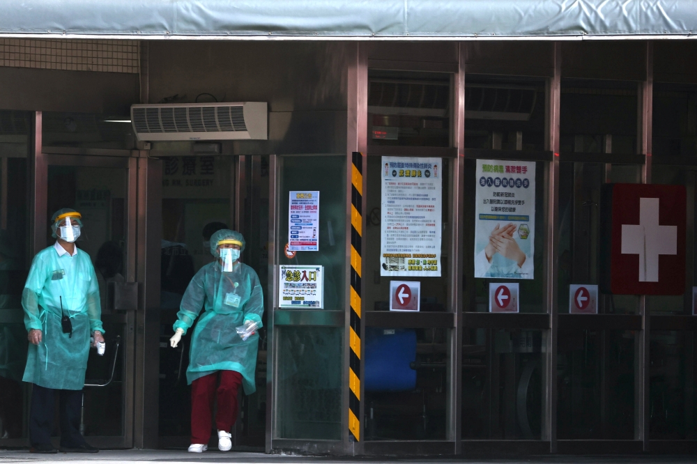 Taiwan's health minister said on Thursday it was still too early to talk about needing to raise the alert level and go into a full lockdown, but the spike in COVID-19 infections on island gave him no reason for optimism.