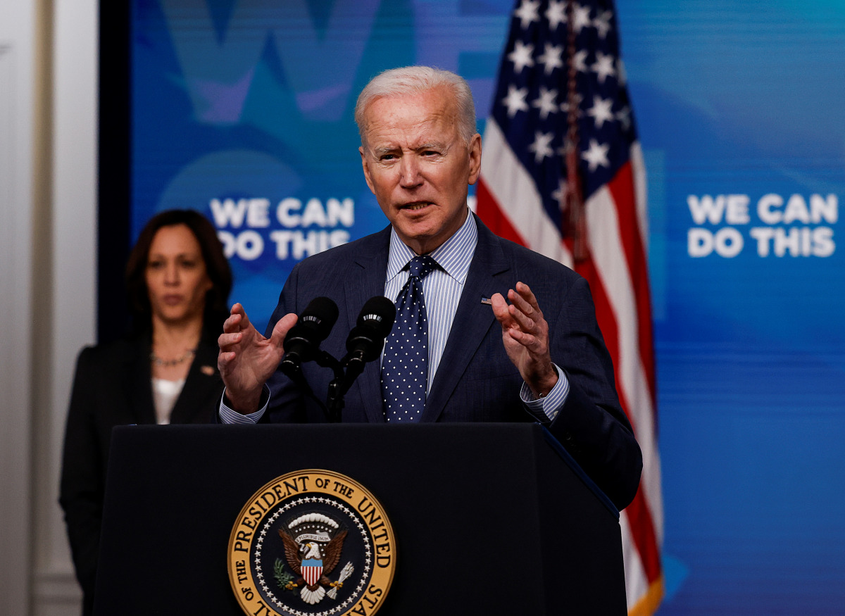 U.S. President Joe Biden delivers remarks on his administration's coronavirus disease (COVID-19) response, as Vice President Kamala Harris stands by in the Eisenhower Executive Office Building's South Court Auditorium at the White House in Washington, U.S