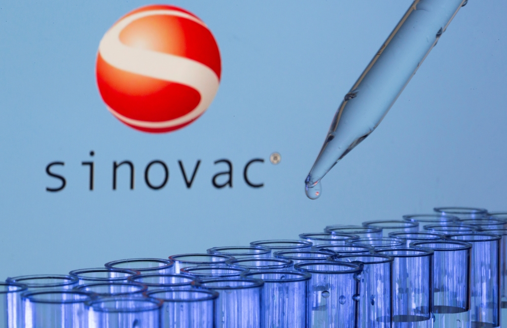 File photo: Test tubes are seen in front of a displayed Sinovac logo in this illustration taken, May 21, 2021. Reuters/Dado Ruvic/Illustration/File Photo