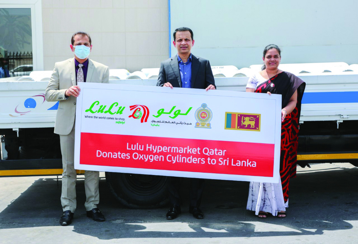 Ambassador of Sri Lanka to  Qatar, H E Mohamed Mafaz Mohideen, receiving oxygen cylinders consignment from Regional Director of Lulu Hypermarket Qatar, Shaijan M O.