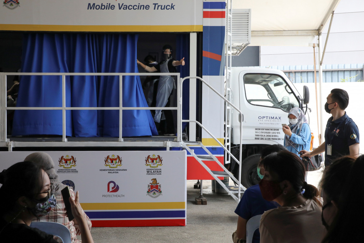 A medical worker gestures inside a coronavirus disease (COVID-19) vaccination truck in Kuala Lumpur, Malaysia June 8, 2021. REUTERS/Lim Huey Teng
