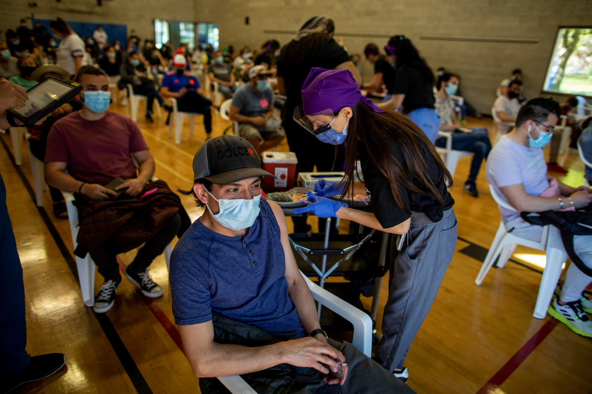 Humber River Hospital doctor Agarwal Seema administers a COVID-19 vaccine at a clinic planned for and organized by the Latino community, an ethno-racial group more at risk of hospitalization from coronavirus disease (COVID-19) according to city of Toronto