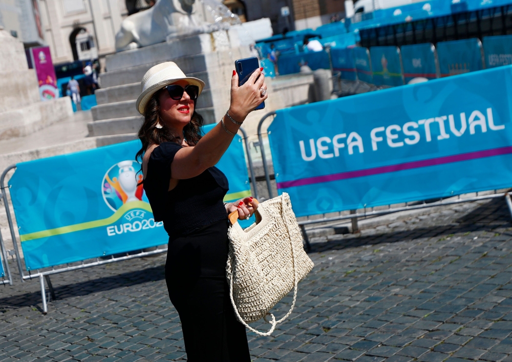 A woman is seen taking a selfie in a fan zone at Piazza del Popolo in Rome REUTERS/Guglielmo Mangiapane
