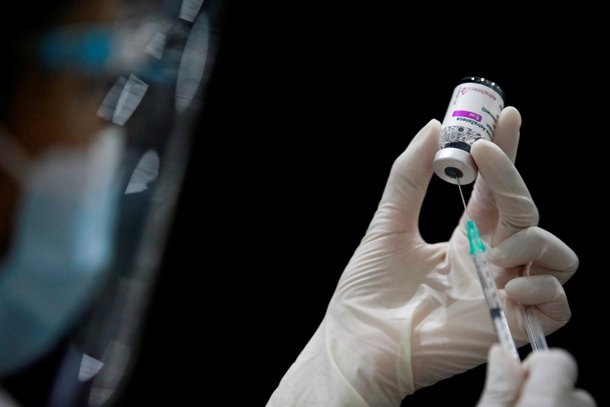 FILE PHOTO: A health worker prepares a dose of AstraZeneca COVID-19 vaccine against the coronavirus disease (COVID-19) as Thailand start mass inoculation at a gymnasium inside Siam Paragon shopping centre, Bangkok, Thailand June 7, 2021. REUTERS/Soe Zeya 