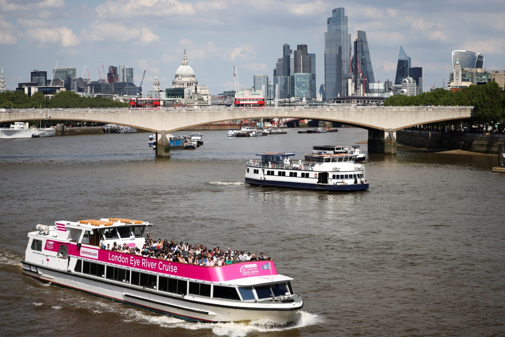 People ride on a sightseeing boat down the River Thames during sunny weather, amid the coronavirus disease (COVID-19) outbreak, in London, Britain, June 5, 2021. REUTERS/Henry Nicholls