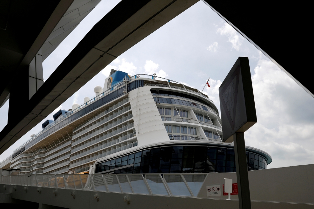 Royal Caribbean's Quantum of the Seas cruise ship docks at Marina Bay Cruise Center after a passenger tested positive for coronavirus disease (COVID-19) during a cruise to nowhere, in Singapore, December 9, 2020. REUTERS/Edgar Su/File Photo
