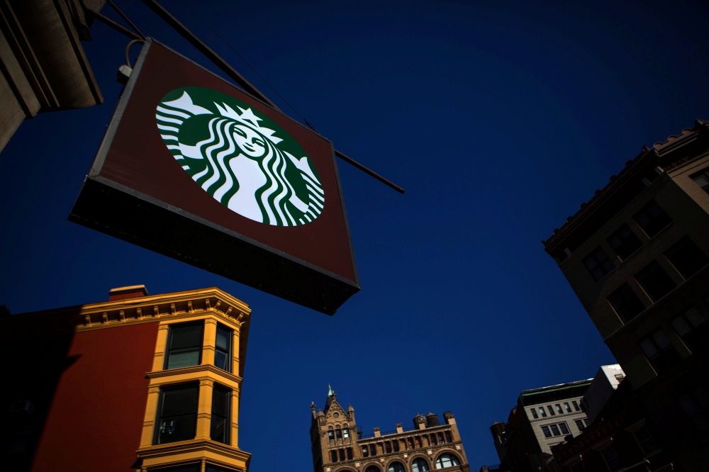 The sign of a Starbucks store is seen in New York January 24, 2014. REUTERS/Eric Thayer/File Photo