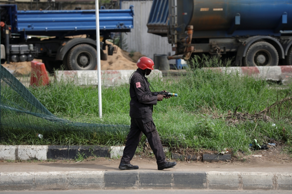 A police officer sets to fire tear gas as he tries to disperse protesters during a June 12 Democracy Day protest at the Gani Fawehinmi Park, in Ojota, Lagos, Nigeria June 12, 2021. REUTERS/Temilade Adelaja