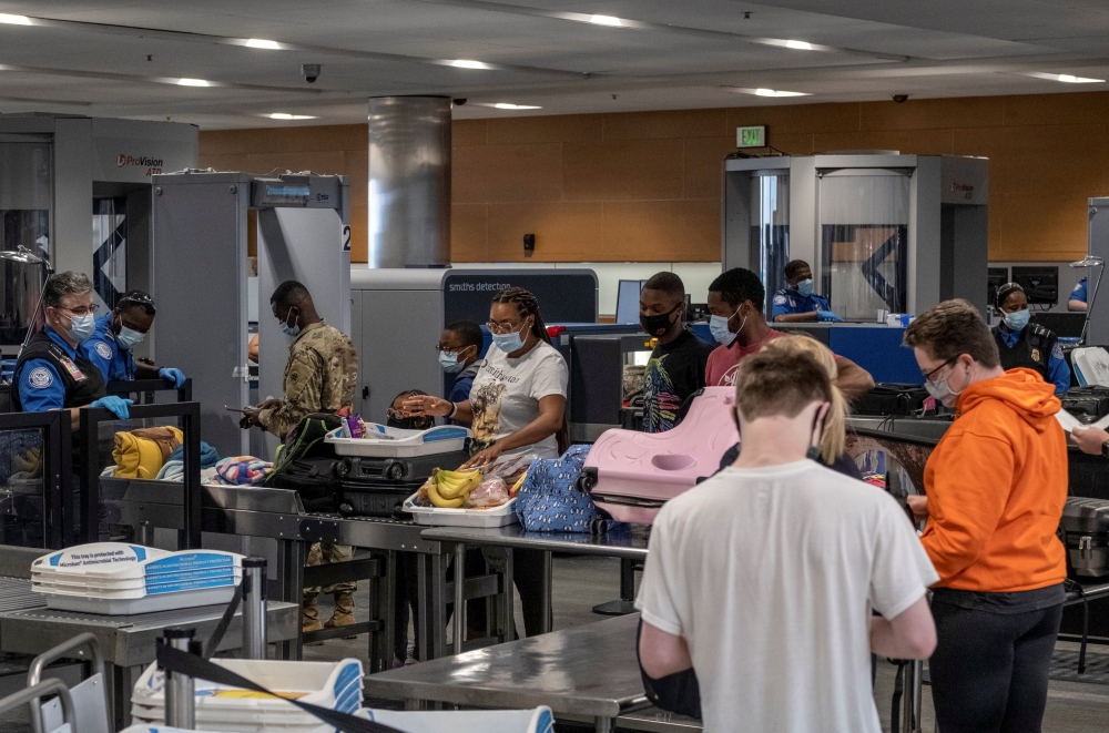 Travellers line up to enter a Transportation Safety Administration (TSA) checkpoint at Detroit Metropolitan Wayne County Airport in Detroit, Michigan, U.S. June 12, 2021. Reuters/Seth Herald