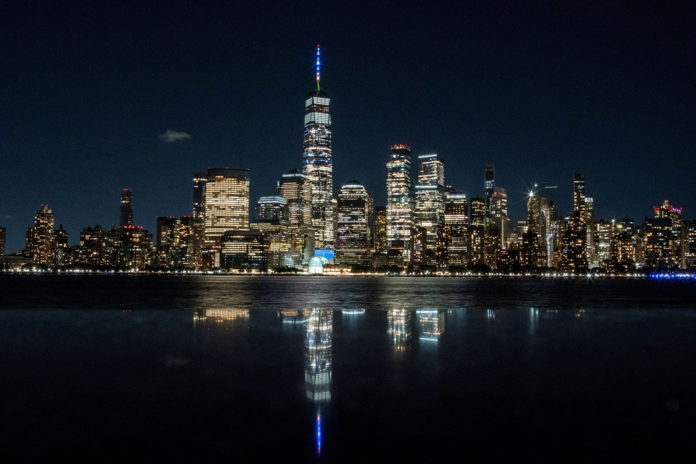The One World Trade Center is lit in Blue and Gold colors, as New York State celebrates reaching a 70 percent vaccination threshold. Reuters/Eduardo Munoz
