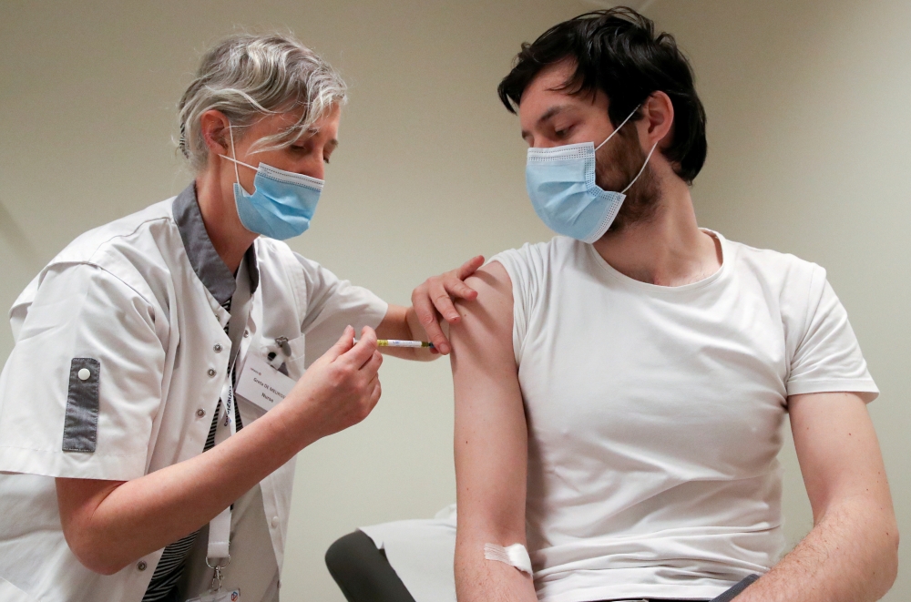 FILE PHOTO: A volunteer receives a dose of CureVac vaccine or a placebo during a study by the German biotech firm CureVac as part of a testing for a new vaccine against the coronavirus disease (COVID-19), in Brussels, Belgium March 2, 2021. REUTERS/Yves H