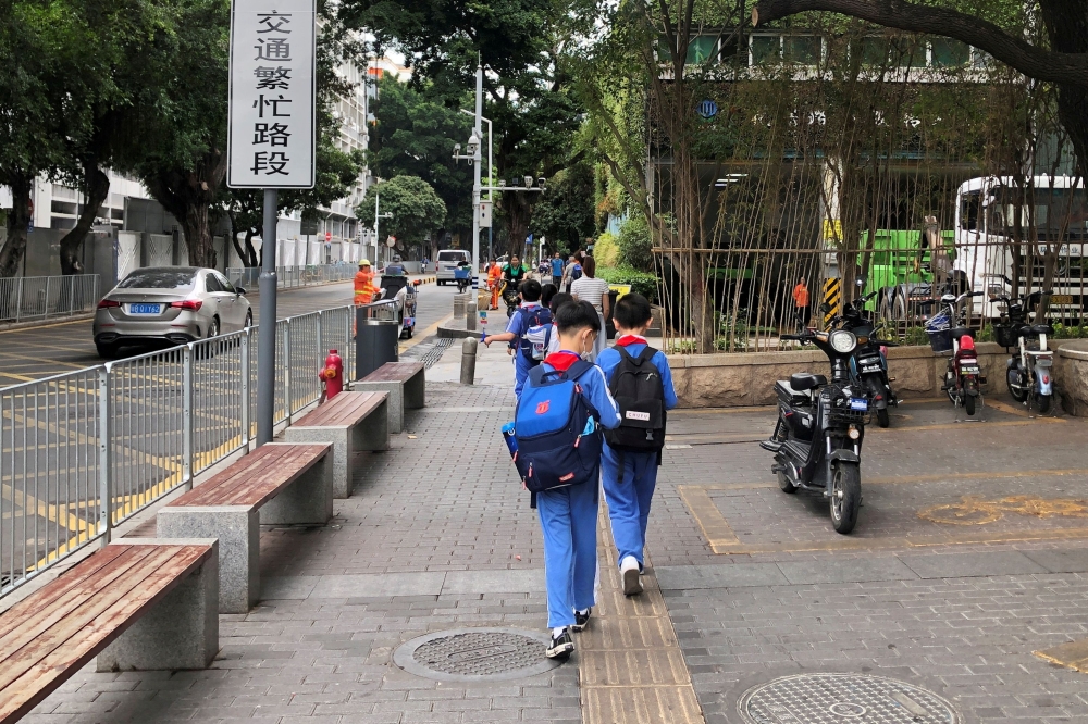 FILE PHOTO: Children leave a school in the Shekou area of Shenzhen, Guangdong province, China April 20, 2021. REUTERS/David Kirton
