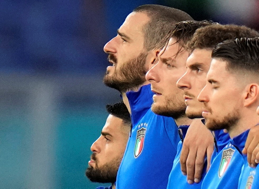Italy's Lorenzo Insigne, Leonardo Bonucci and Ciro Immobile line up during the national anthems before the match Pool via REUTERS/Alessandra Tarantino