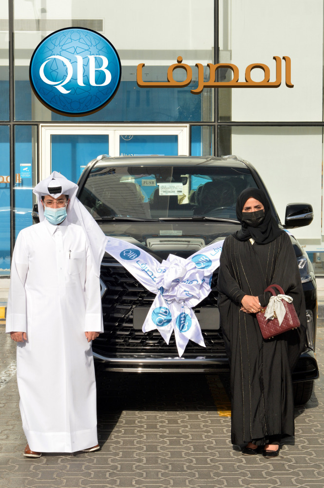 Qatar Islamic Bank customer Khloud Rashed Al Marri (right) posing with her new Lexus LX 570 during QIB’s third and last draw for its ‘Salary Transfer’ offer recently.  