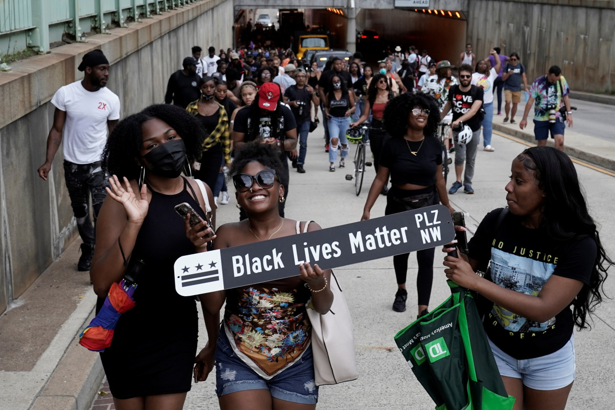 People march as they celebrate Juneteenth, which commemorates the end of slavery in Texas, two years after the 1863 Emancipation Proclamation freed slaves elsewhere in the United States, in Washington, D.C. U.S., June 19, 2021. REUTERS/Ken Cedeno
