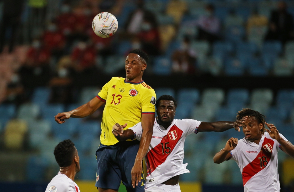 Colombia's Yerry Mina in action with Peru's Christian Ramos Reuters/Diego Vara