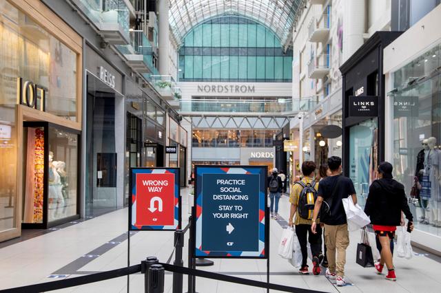 FILE PHOTO: People walk in the Eaton Centre shopping mall. REUTERS/Carlos Osorio/File Photo