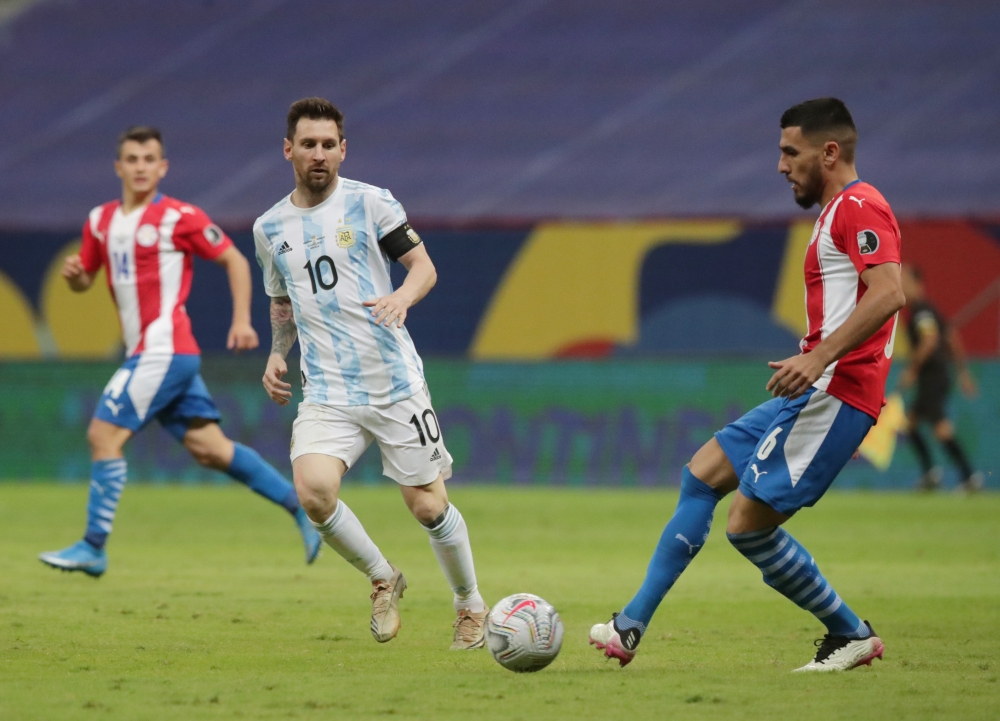 Paraguay's Junior Alonso in action with Argentina's Lionel Messi REUTERS/Henry Romero
 