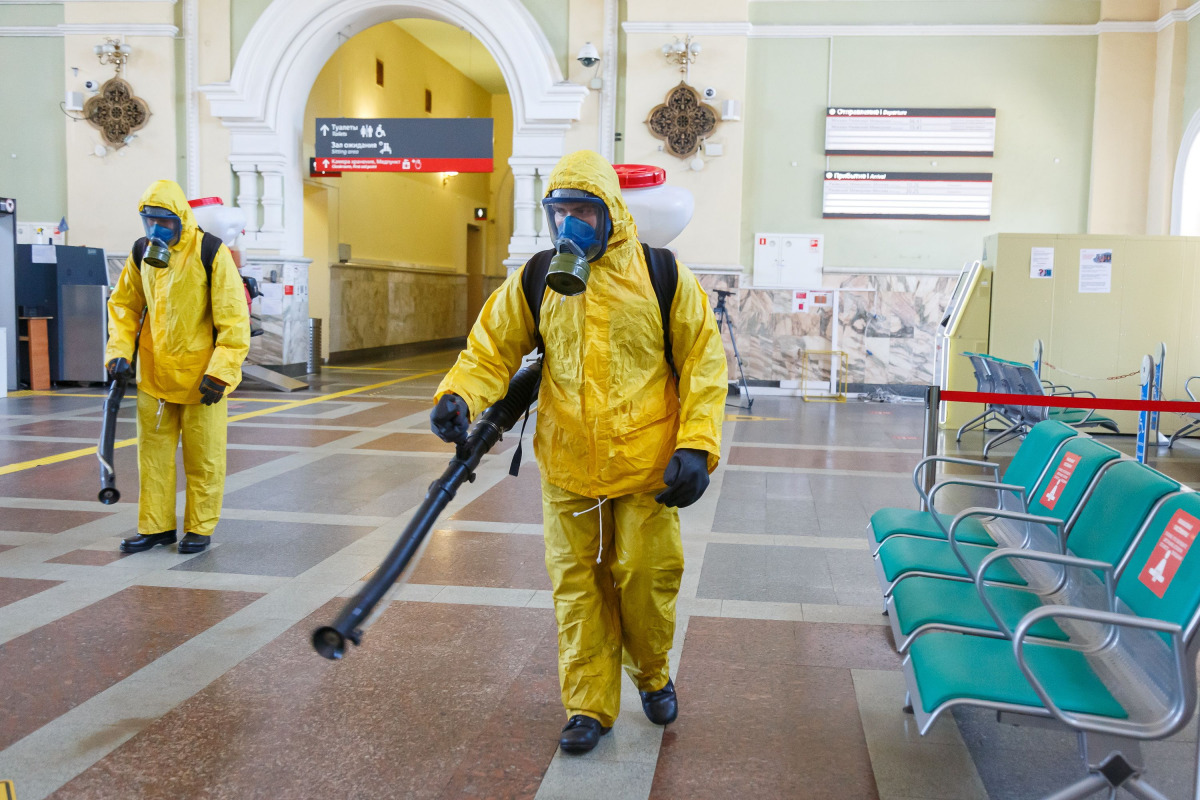 Specialists wearing personal protective equipment (PPE) spray disinfectant while sanitizing the Rizhsky Railway Station, one of the measures to curb the spread of the coronavirus disease (COVID-19), in Moscow, Russia June 17, 2021. Moscow Division of Russ