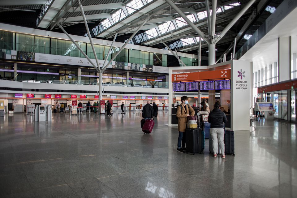 Passengers wearing face masks are seen at the terminal of Warsaw Chopin Airport following an outbreak of coronavirus disease in Warsaw, Poland, 13 March 2020. Dawid Zuchowicz/Agencja Gazeta/via REUTERS

