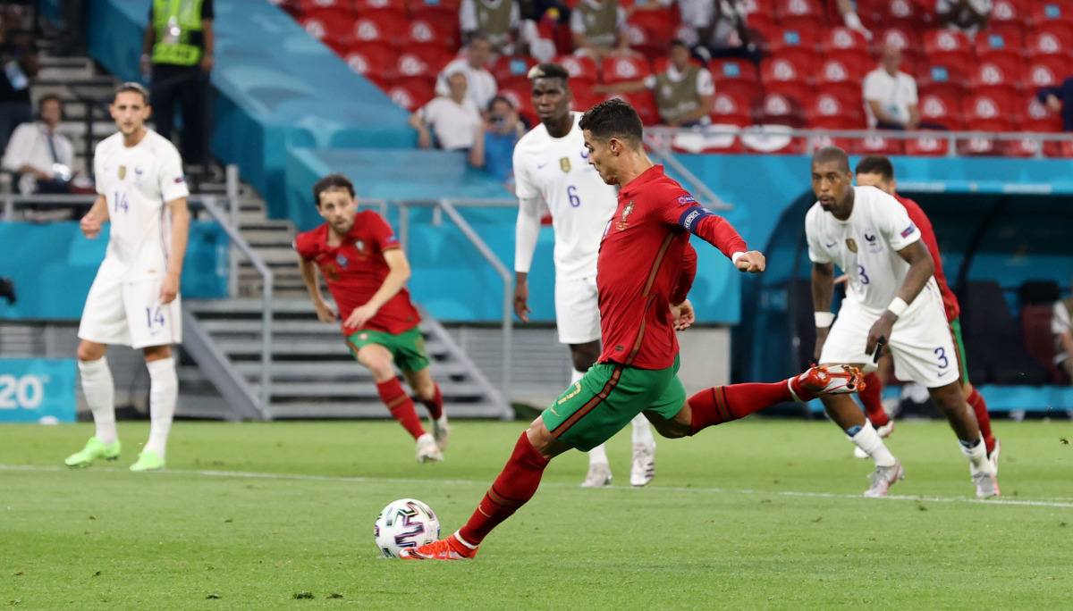 Soccer Football - Euro 2020 - Group F - Portugal v France - Puskas Arena, Budapest, Hungary - June 23, 2021 Portugal's Cristiano Ronaldo scores their second goal from the penalty spot Pool via REUTERS/Bernadett Szabo
