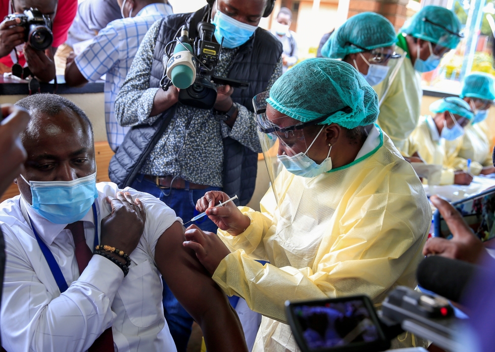 A health worker vaccinates a man against the coronavirus disease (COVID-19), in Harare, Zimbabwe, February 18, 2021. REUTERS/Philimon Bulawayo/File Photo