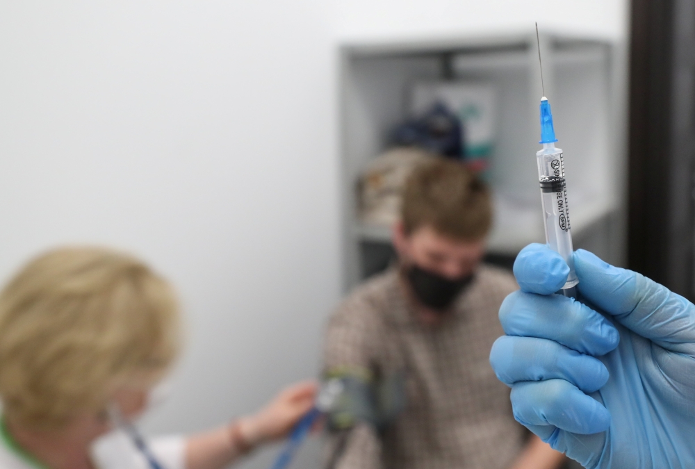 A healthcare worker prepares a dose of Sputnik V (Gam-COVID-Vac) vaccine against the coronavirus disease (COVID-19) at a vaccination centre for the Yandex Go drivers and couriers in Moscow, Russia June 24, 2021. REUTERS/Evgenia Novozhenina