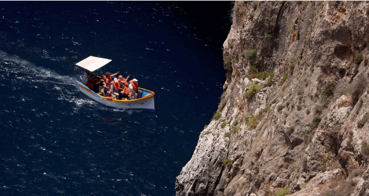 Tourists on a boat visit the Blue Grotto outside Zurrieq, Malta June 24, 2021. REUTERS/Darrin Zammit Lupi