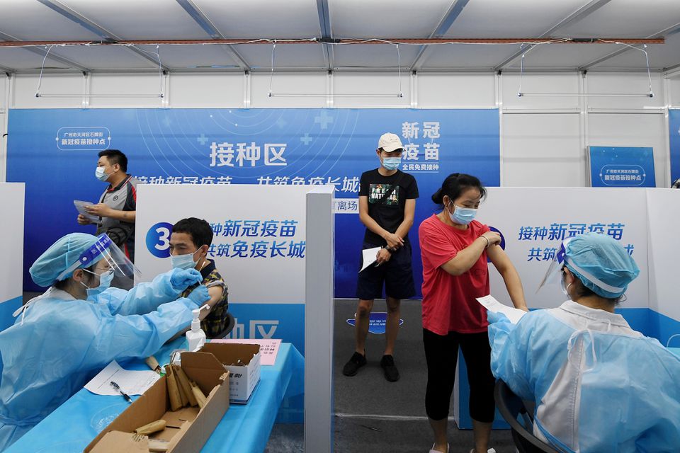 Residents receive vaccines against the coronavirus disease (COVID-19) at a makeshift vaccination site in Guangzhou, Guangdong province, China June 21, 2021. cnsphoto via REUTERS


