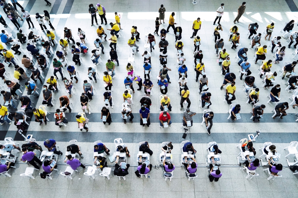 People wait to receive the second dose of Sinovac's COVID-19 vaccine against the coronavirus disease (COVID-19) at the Central Vaccination Center, inside the Bang Sue Grand Station, Thailand, June 21, 2021. REUTERS/Athit Perawongmetha